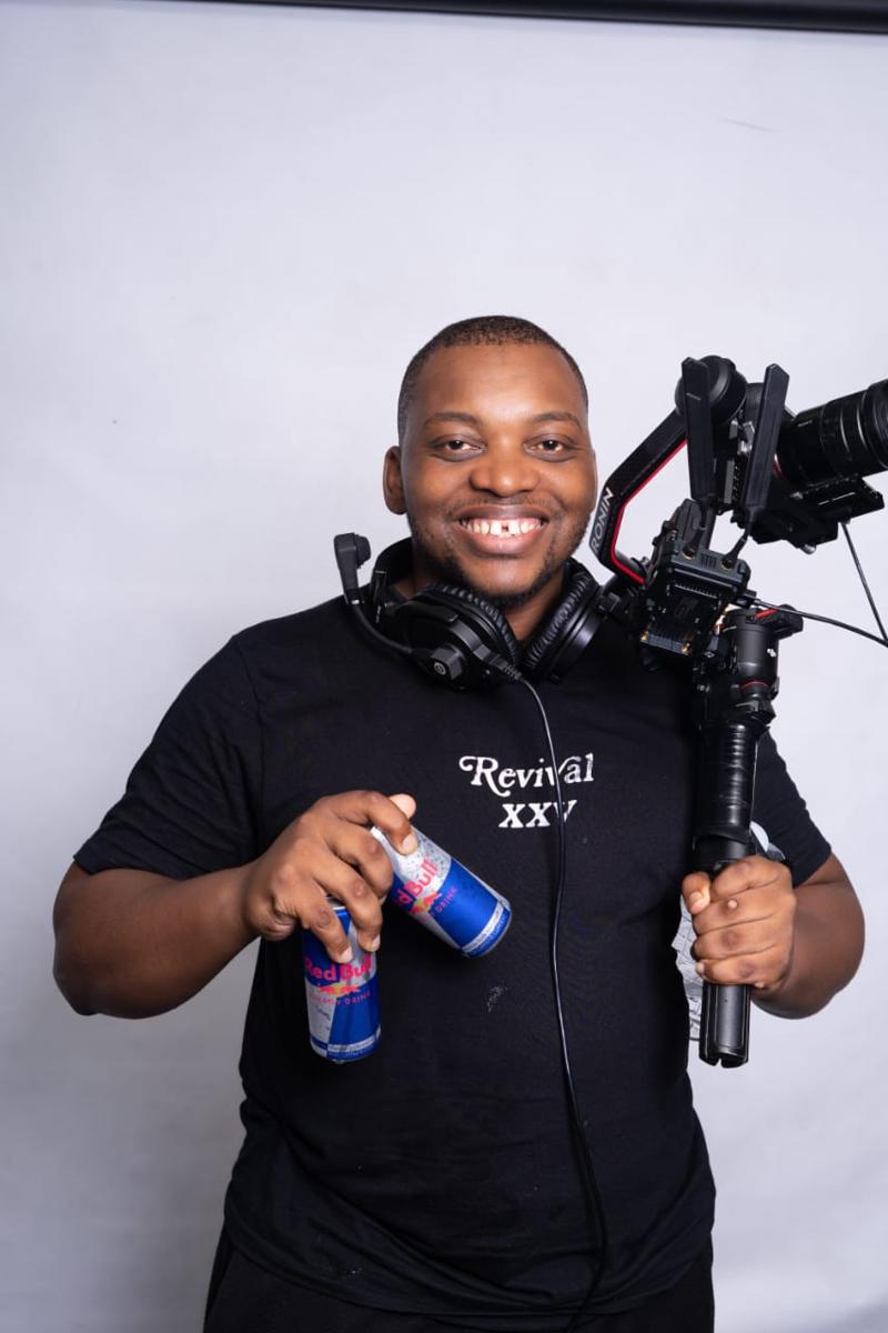Mangaliso Sifumba &mdash; photographer and videographer at Inline Media, holding a gimbal-mounted cinema camera